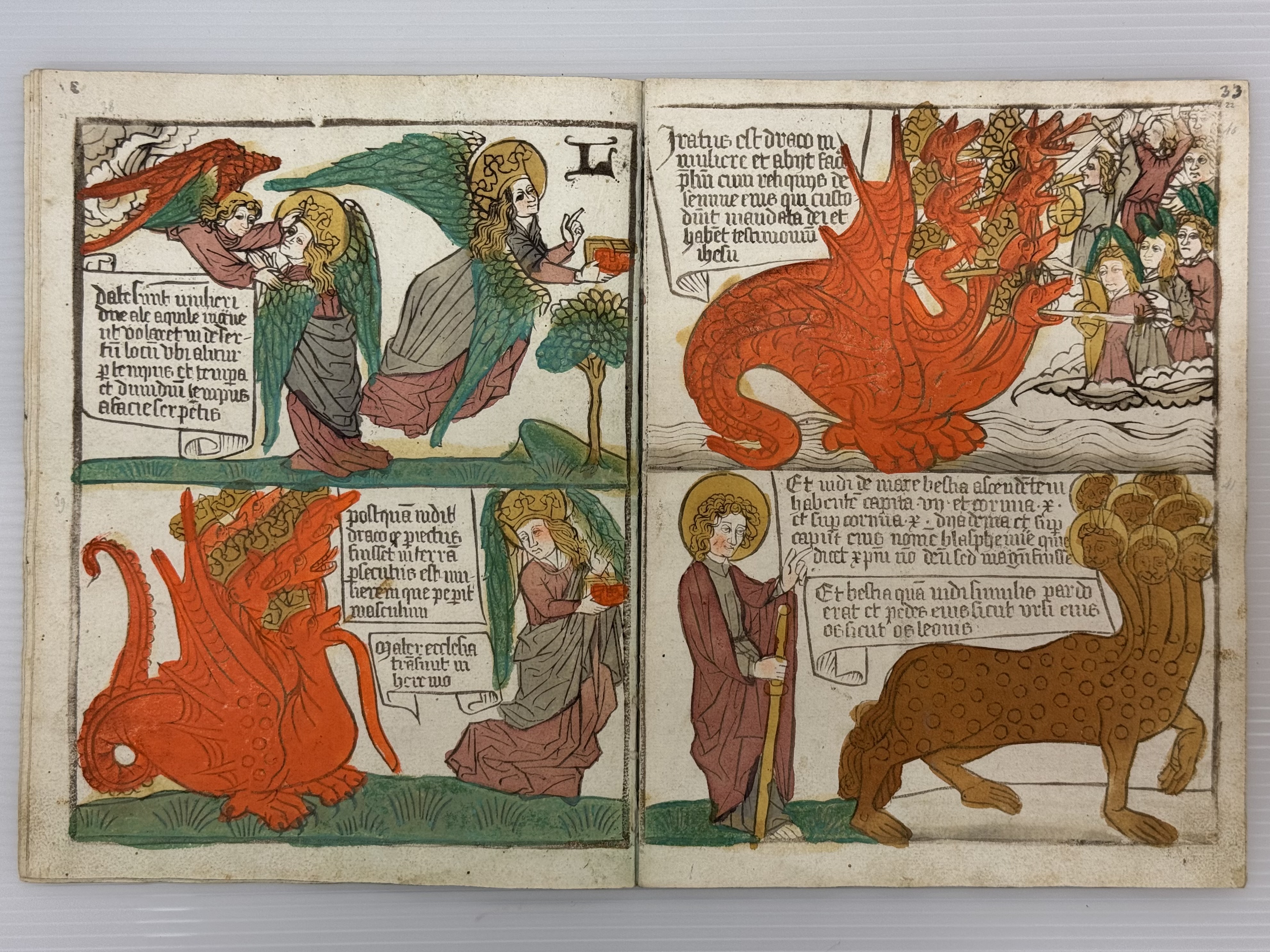 An illustrated manuscript page shows two angels, a red dragon, and a multi-headed beast, with text captions explaining the imagery.