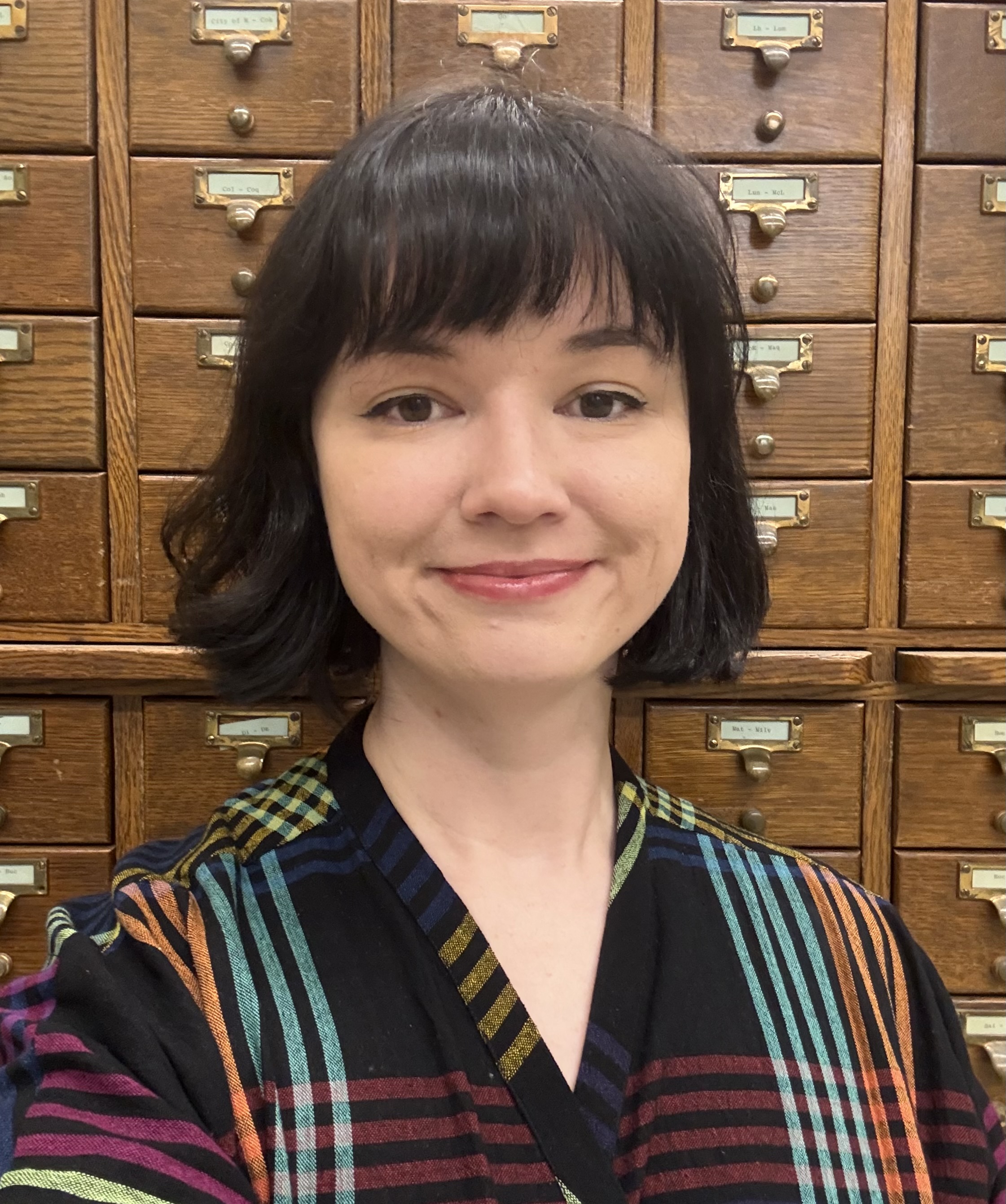 Photo of Sarah Finn in front of a card catalog